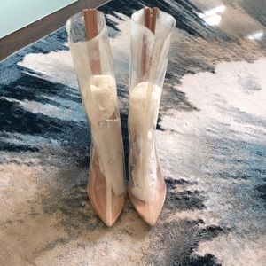 Clear boots with gold/beige trim and clear heels.